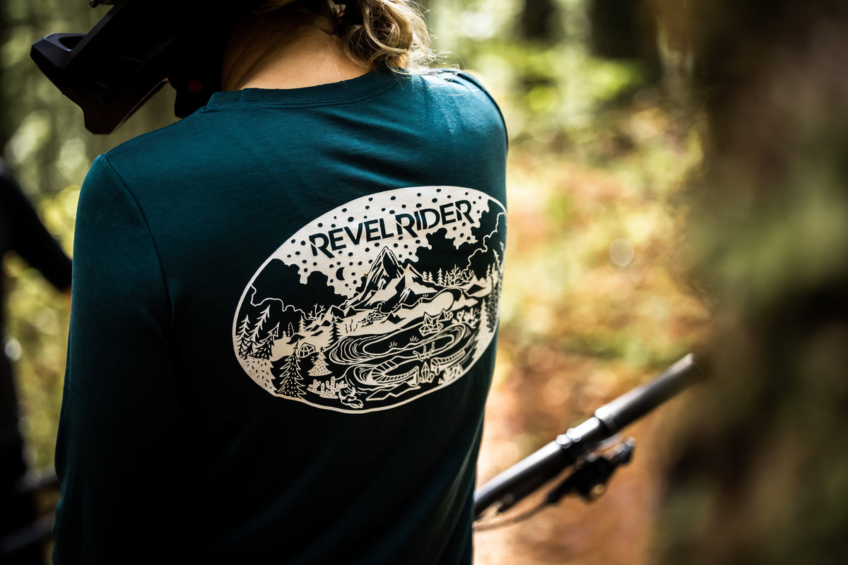 Rider outdoors wearing Revel Rider graphic tee with back artwork visible